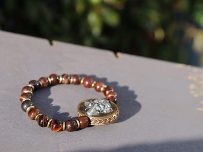 Red Tiger Eye and Beautiful 3D silvertone metal Ganesh decoration on both front as back.