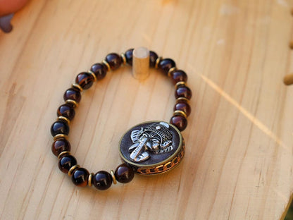 Red Tiger Eye and Beautiful 3D silvertone metal Ganesh decoration on both front as back.