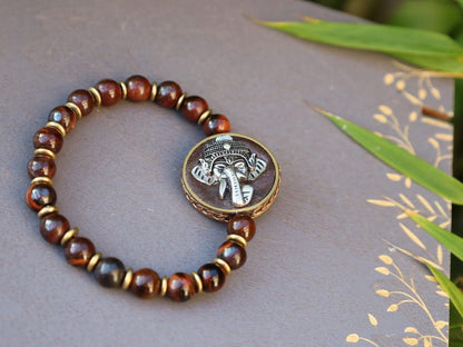 Red Tiger Eye and Beautiful 3D silvertone metal Ganesh decoration on both front as back.