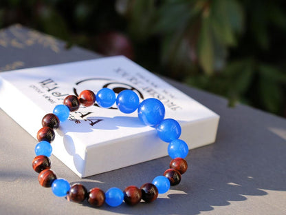 A bracelet made with Royal Blue Jade and Red Tiger Eye beads is a striking combination that blends elegance and vibrant energy.