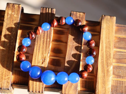 A bracelet made with Royal Blue Jade and Red Tiger Eye beads is a striking combination that blends elegance and vibrant energy.