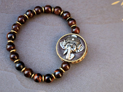Red Tiger Eye and Beautiful 3D silvertone metal Ganesh decoration on both front as back.