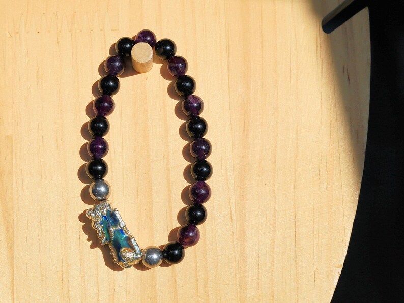 This Pixiu Amulet Bracelet features Jade | Amethyst | Black Onyx. believed to bring wealth,good fortune, and protection from negative energy