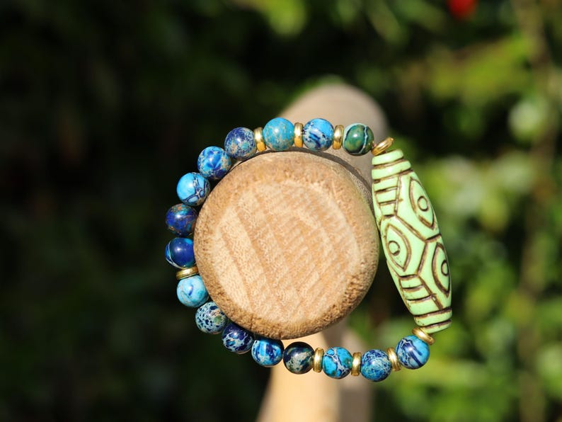 Tibetan Six Phoenix’s Eyed Bracelet – Hand-Carved Turquoise with Sea Sediment Turquoise Bead. Transformation, protection, and enlightenment.
