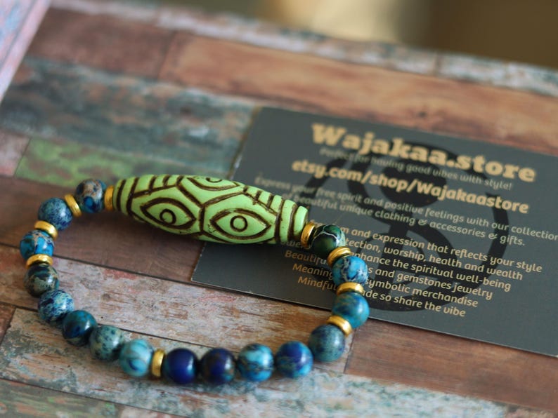Tibetan Six Phoenix’s Eyed Bracelet – Hand-Carved Turquoise with Sea Sediment Turquoise Bead. Transformation, protection, and enlightenment.