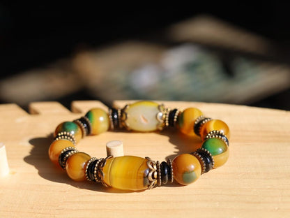 Tibetan Dragon Grain Dzi Bead Bracelet – Old Agate Collection. Experience the timeless artistry and mystic energy of the Himalayas