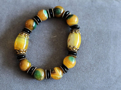 Tibetan Dragon Grain Dzi Bead Bracelet – Old Agate Collection. Experience the timeless artistry and mystic energy of the Himalayas