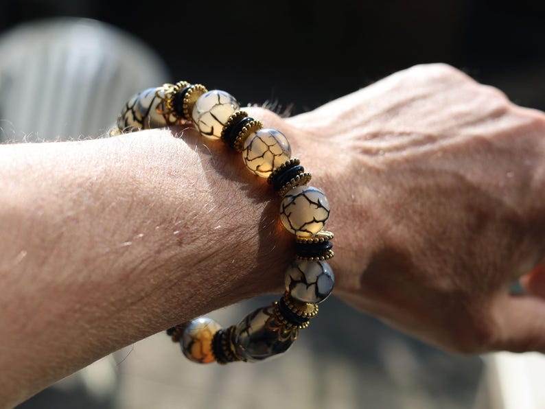 Tibetan Crackle Agate Bracelet – Golden Harmony Collection. Embody strength, wisdom, and grounding energy with this stunning item
