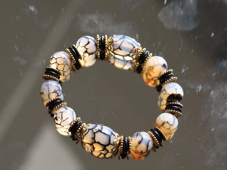 Tibetan Crackle Agate Bracelet – Golden Harmony Collection. Embody strength, wisdom, and grounding energy with this stunning item
