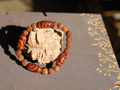 Tibetan Two-Eyed Dzi & Rudraksha Bracelet – Harmony and Unity. it represents harmony, love, and partnership