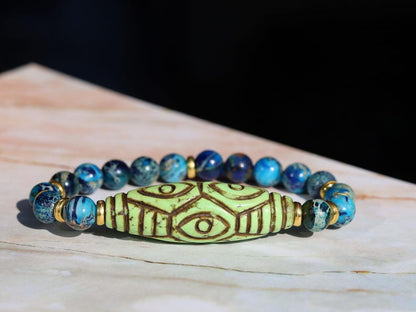 Tibetan Six Phoenix’s Eyed Bracelet – Hand-Carved Turquoise with Sea Sediment Turquoise Bead. Transformation, protection, and enlightenment.
