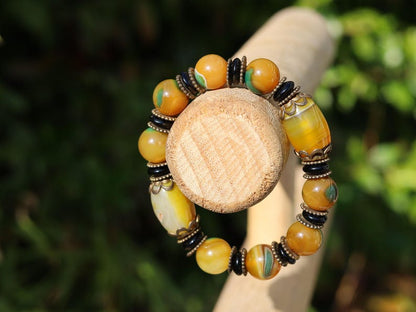 Tibetan Dragon Grain Dzi Bead Bracelet – Old Agate Collection. Experience the timeless artistry and mystic energy of the Himalayas
